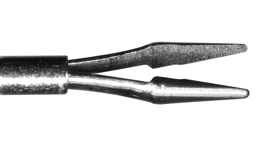 Close-up image of the FINESSE Advanced DSP Tip MAXGrip Forceps showing the microtextured grasping surfaces designed for secure handling of fibrous or adherent membranes