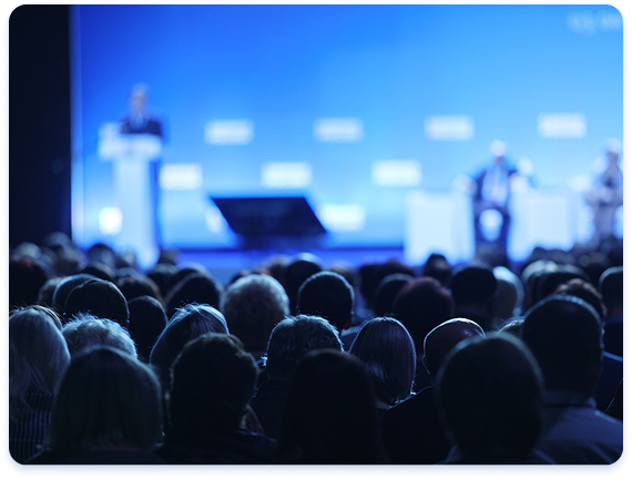Large audience attending a keynote presentation at a professional conference