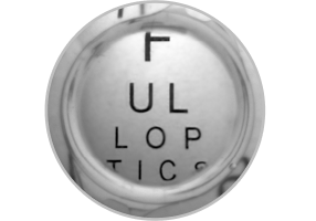 Close-up image of an enVista IOL with letters behind it, showing the use of the limited 4.9 mm aspheric optic.