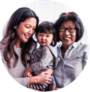 Asian mother, daughter, and grandmother smiling