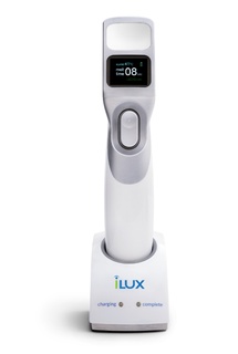 Systane iLux device sitting on the charging station