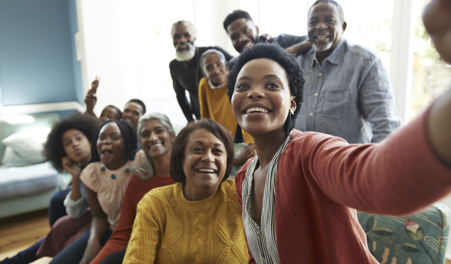 Group of people smiling and taking a selfie photo
