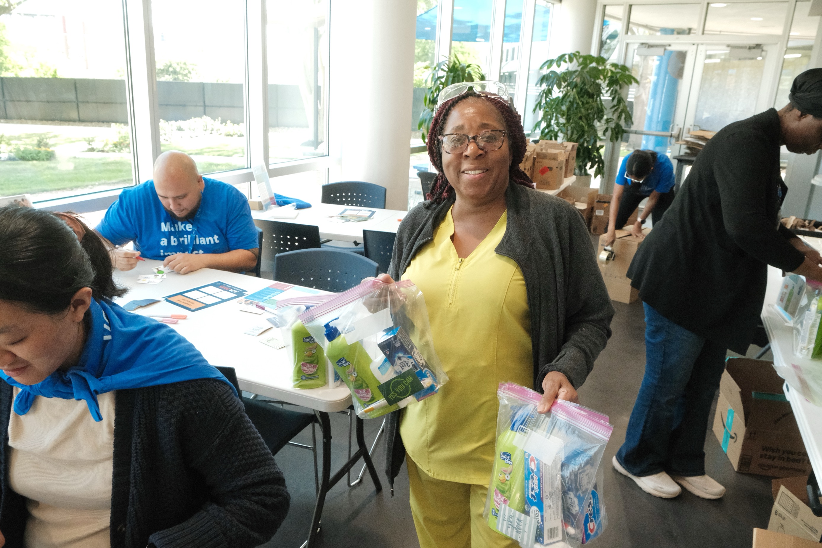 Group of Alcon employees assembling bags of basic toiletries to give to people in need