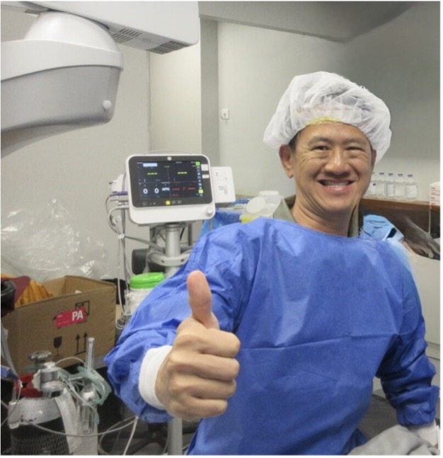 Picture of a smiling surgeon giving a thumbs up sign
