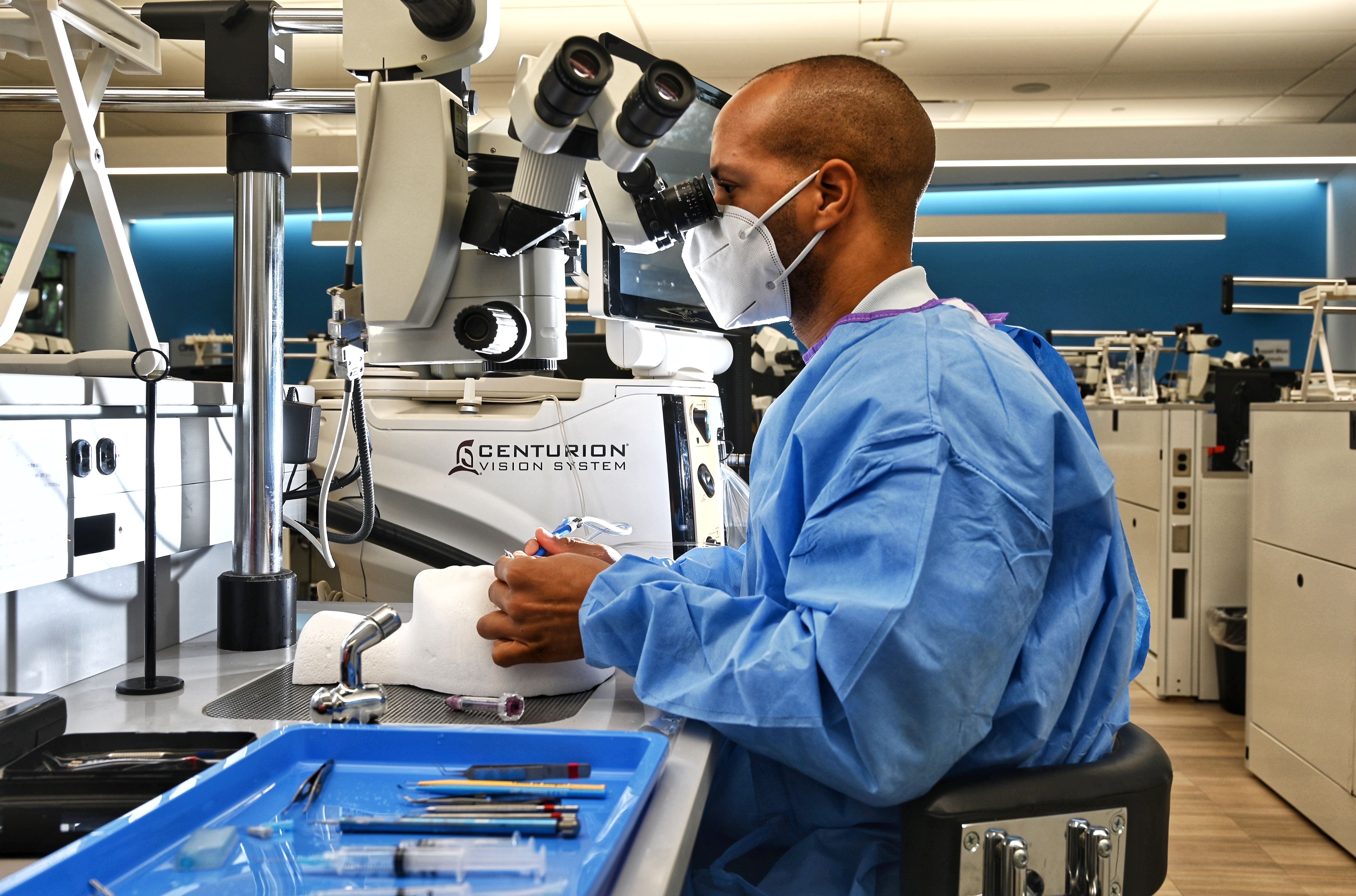 Man in scrubs and mask in Phaco training at Alcon Experience Center