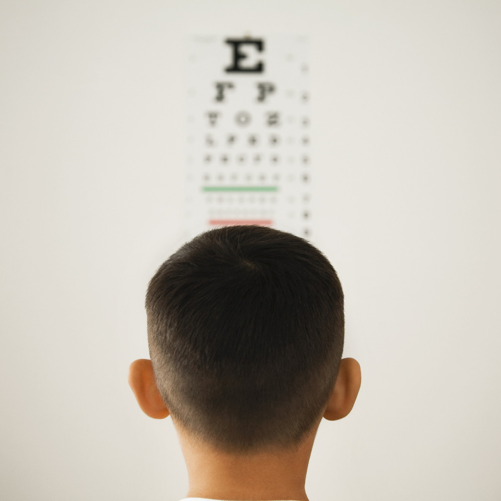 A man looking at an eye chart