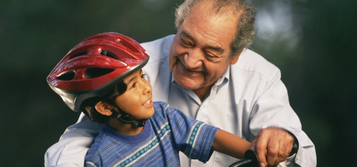 Older gentleman and a child riding a bicycle