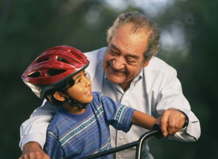Older gentleman and a child riding a bicycle