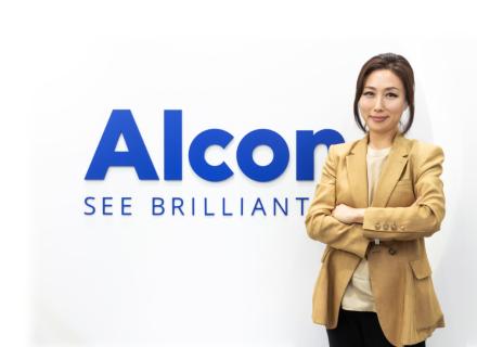 Nicole Bang standing next to Alcon sign