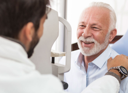 Paul Delatore, smiling at another person