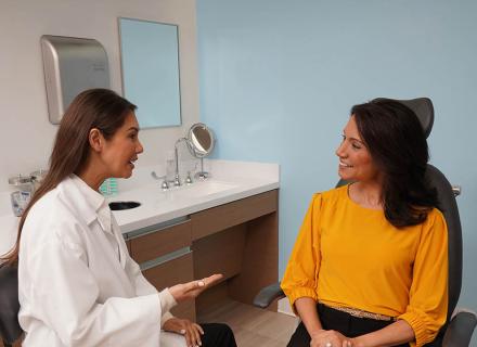 Eye care professional speaking with patient