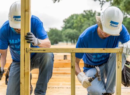 Alcon volunteers building a home