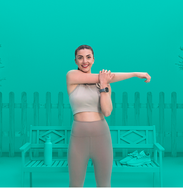 Woman in athletic wear stretching her arm in front of a bench with a water bottle and sneakers, set against a teal background with potted trees and a fence
