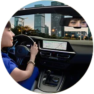 Woman in bed using her phone in low light, representing everyday visual comfort needs